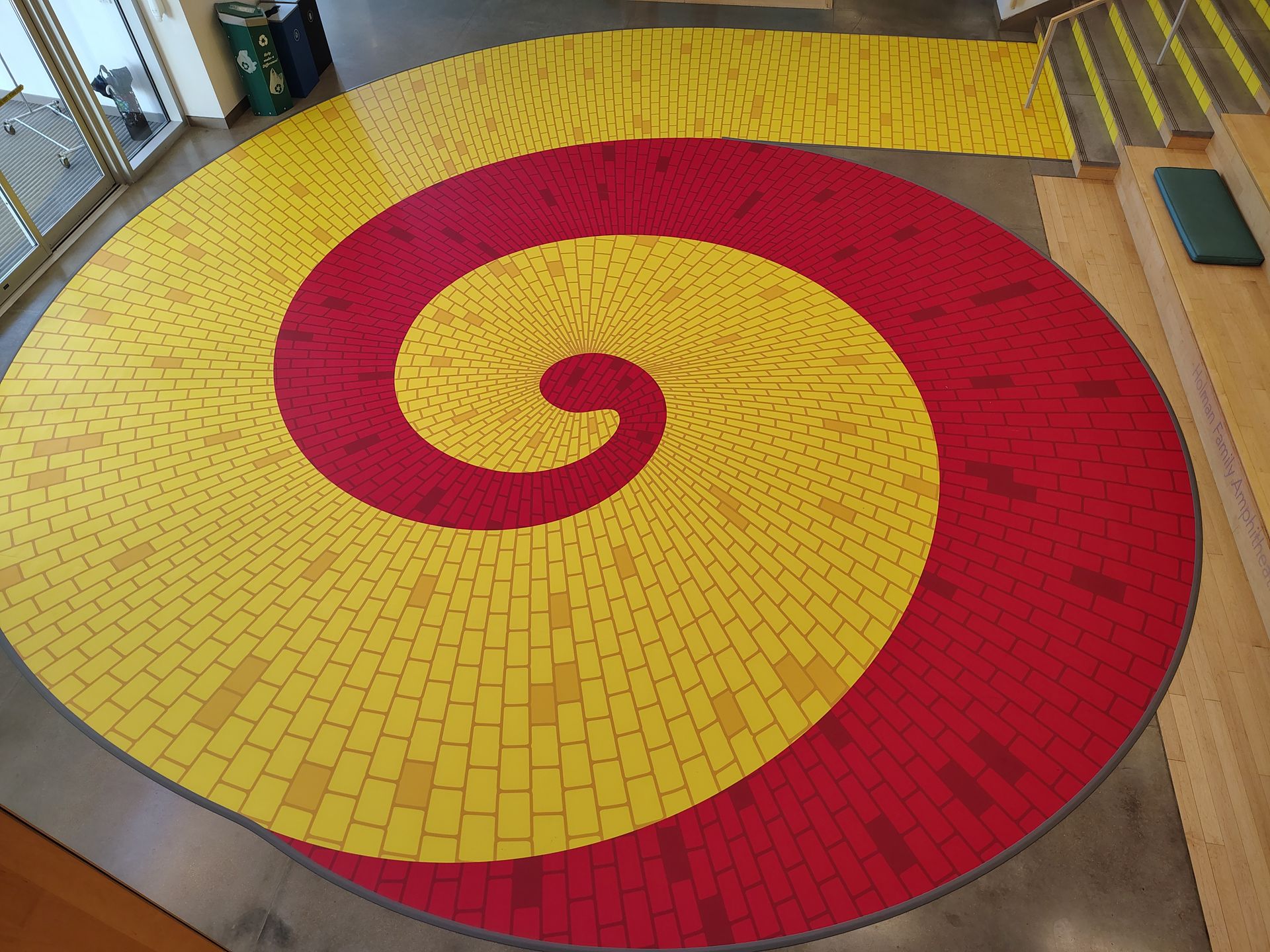 Red and yellow spiral mosaic floor in an indoor public space