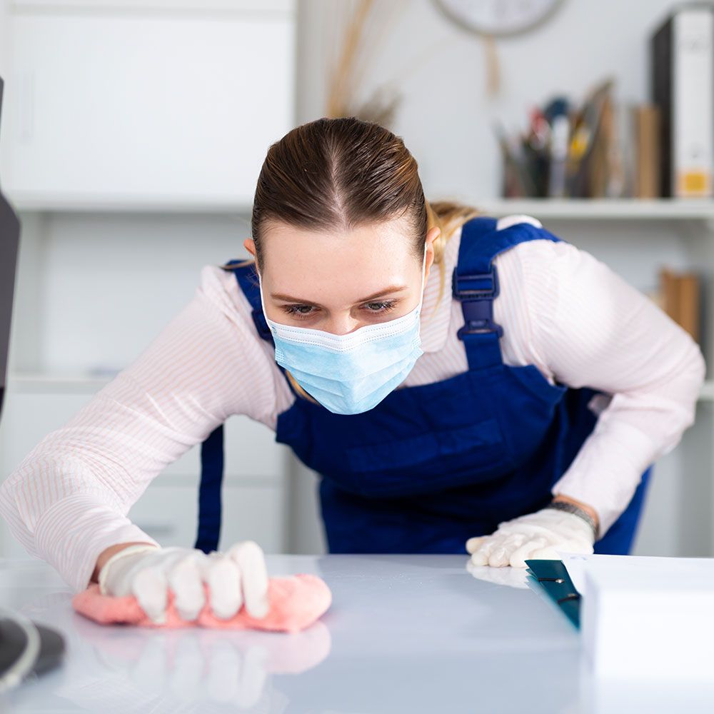 Masked Woman Focused on Cleaning