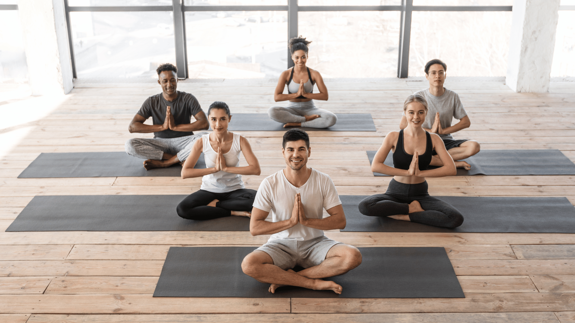 Adults participating in supportive beginner yoga classes with guided poses and breathing instruction