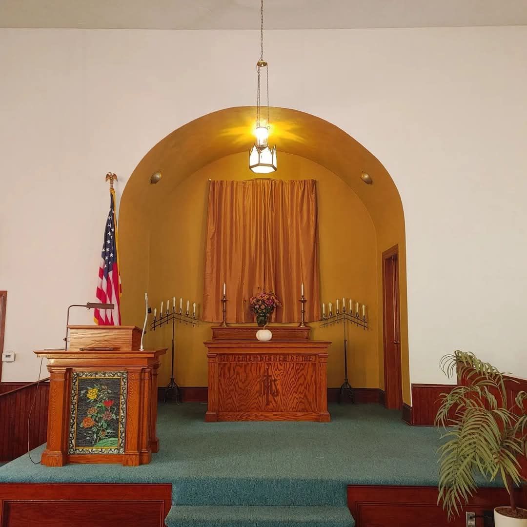 The inside of a church with a podium and altar