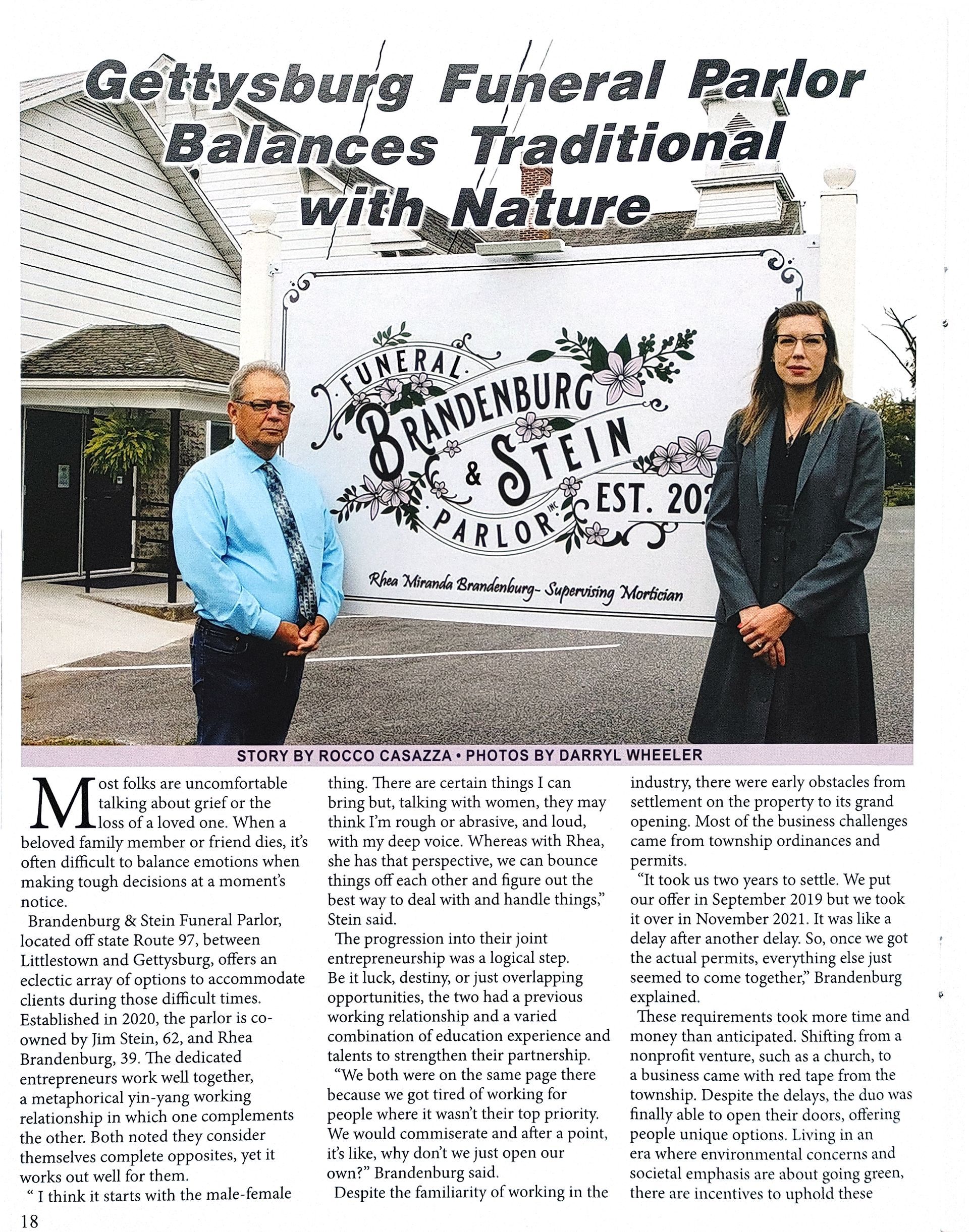 A man and a woman are standing in front of a sign that says gettsburg funeral parlor balances traditional with nature.
