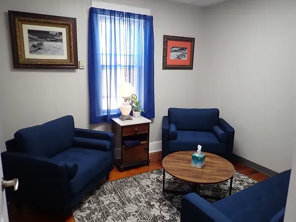 There are two chairs and a coffee table in the room.