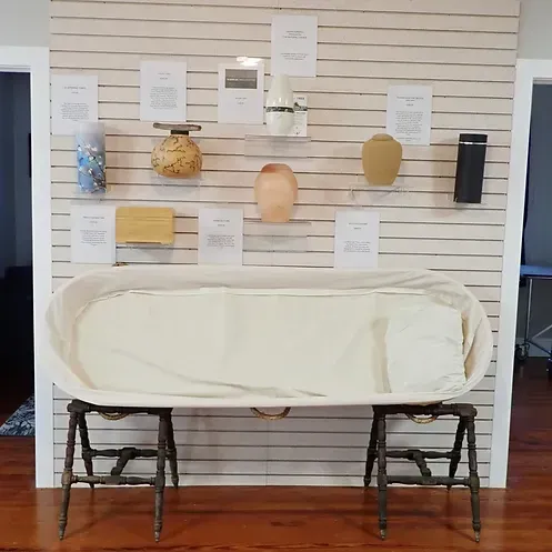 A large white bathtub is sitting on two wooden stools in front of a wall.