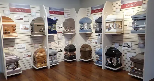 There are many different types of coffins on display in this room.
