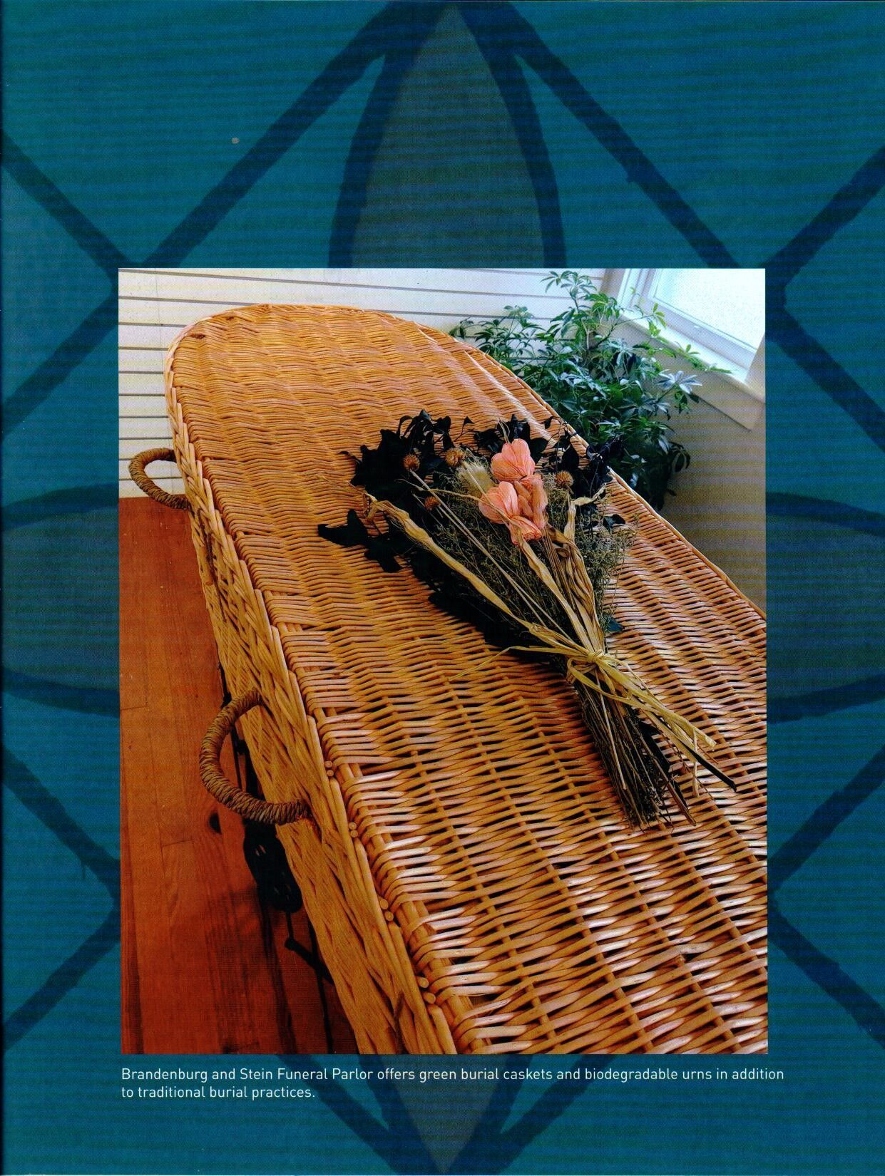 A picture of a wicker coffin with flowers on it