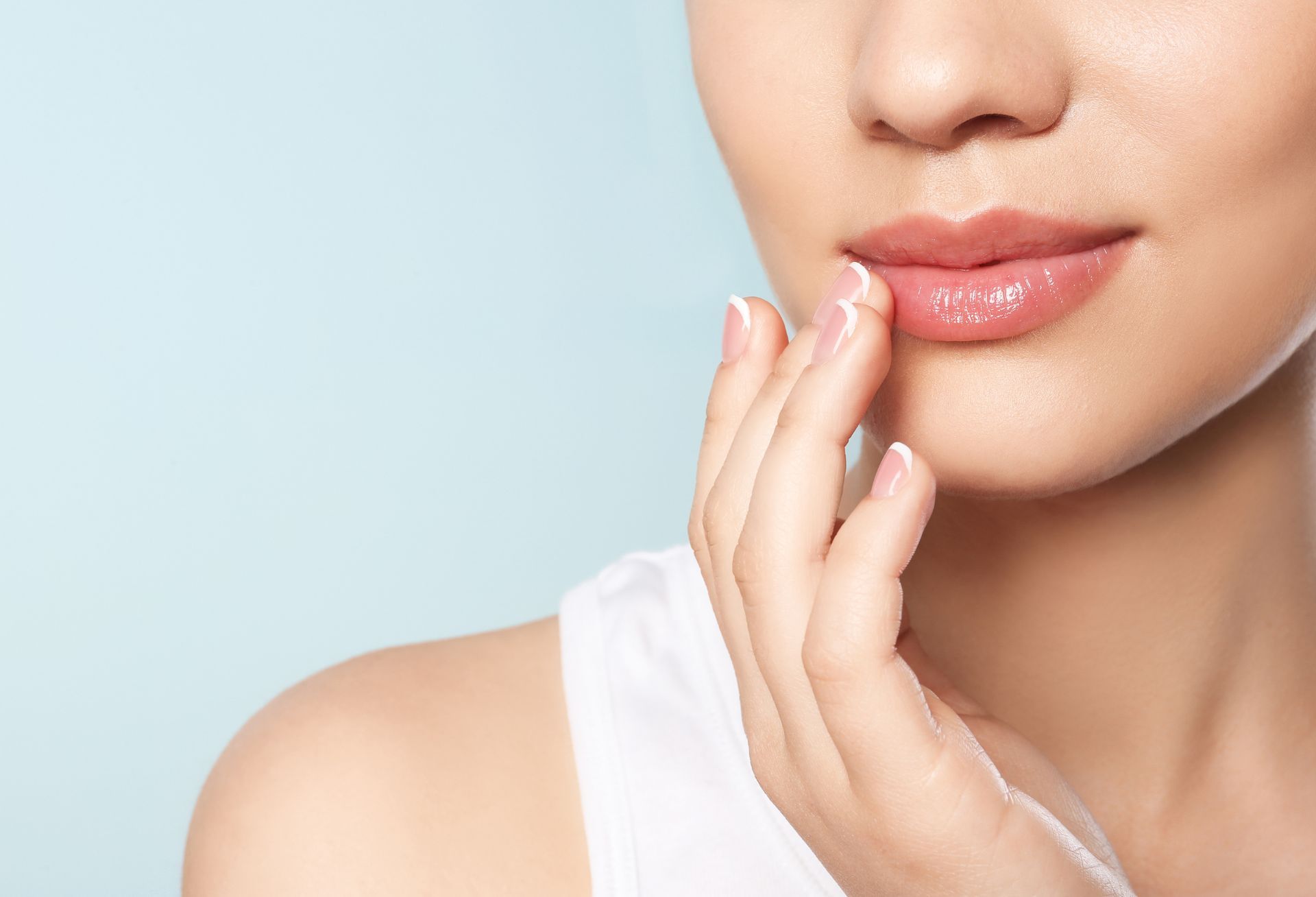 closeup of woman touching her full lips