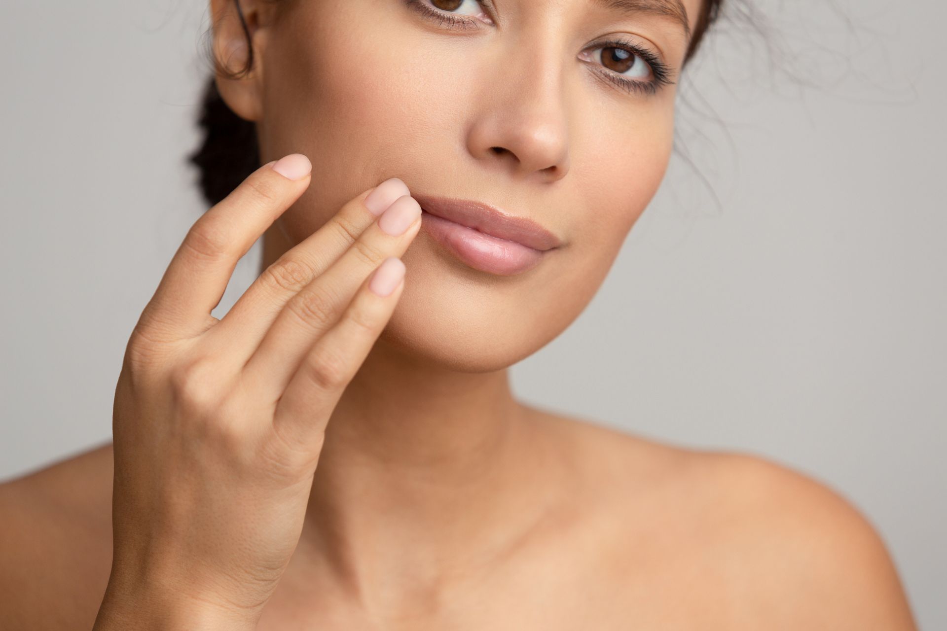mature woman touching full lips after laser lip treatment