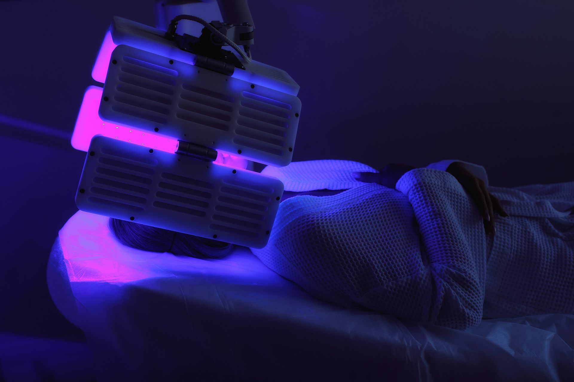 A Woman Is Getting A Purple Light Treatment On Her Face – Terrigal, NSW - Anjule Beauty Therapy