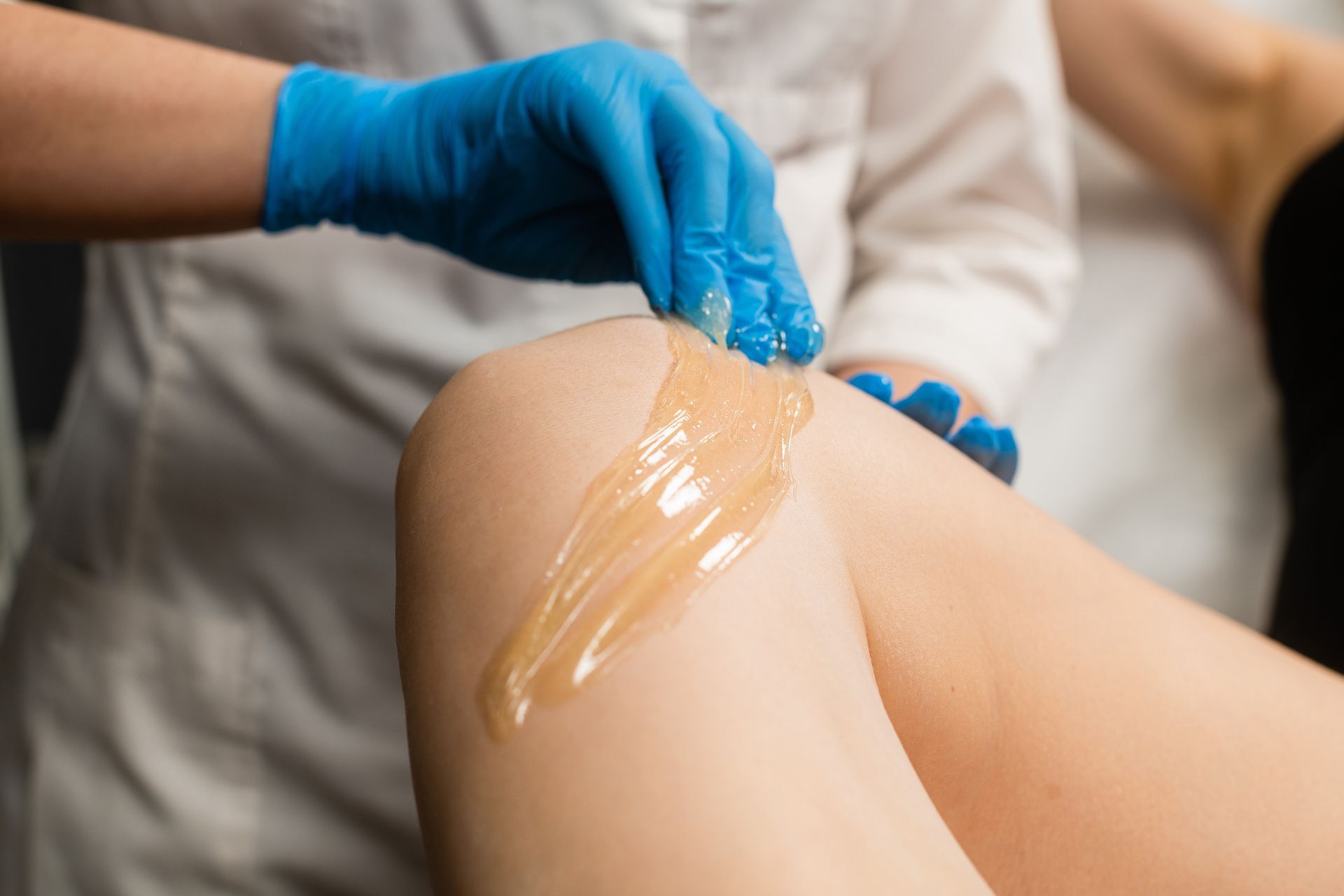 A Woman Is Getting A Sugaring Treatment On Her Leg – Terrigal, NSW - Anjule Beauty Therapy