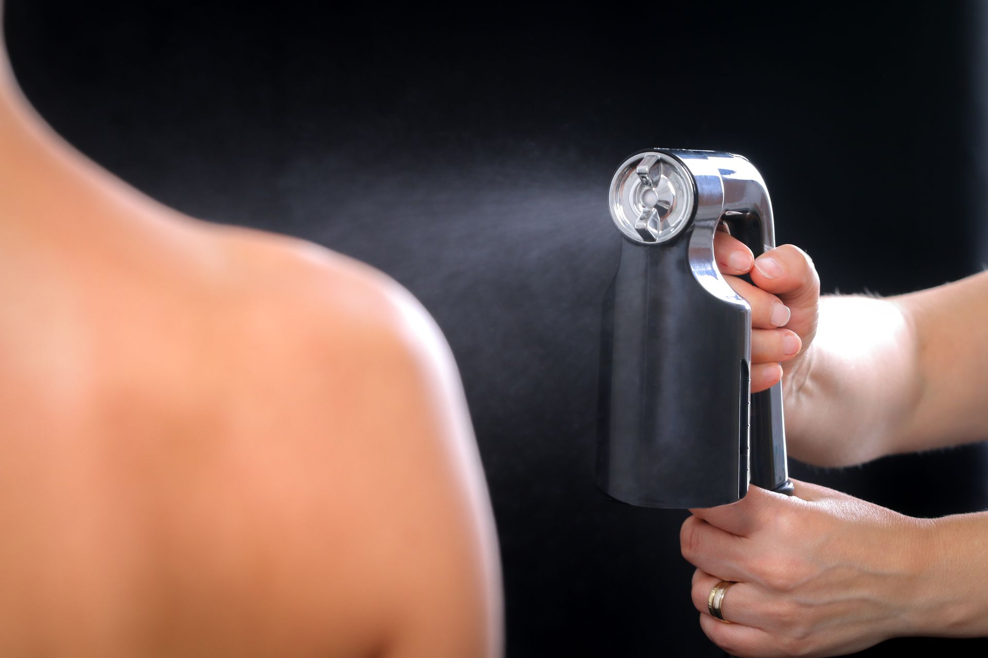 A Woman Is Getting A Spray Tan On Her Back – Terrigal, NSW - Anjule Beauty Therapy