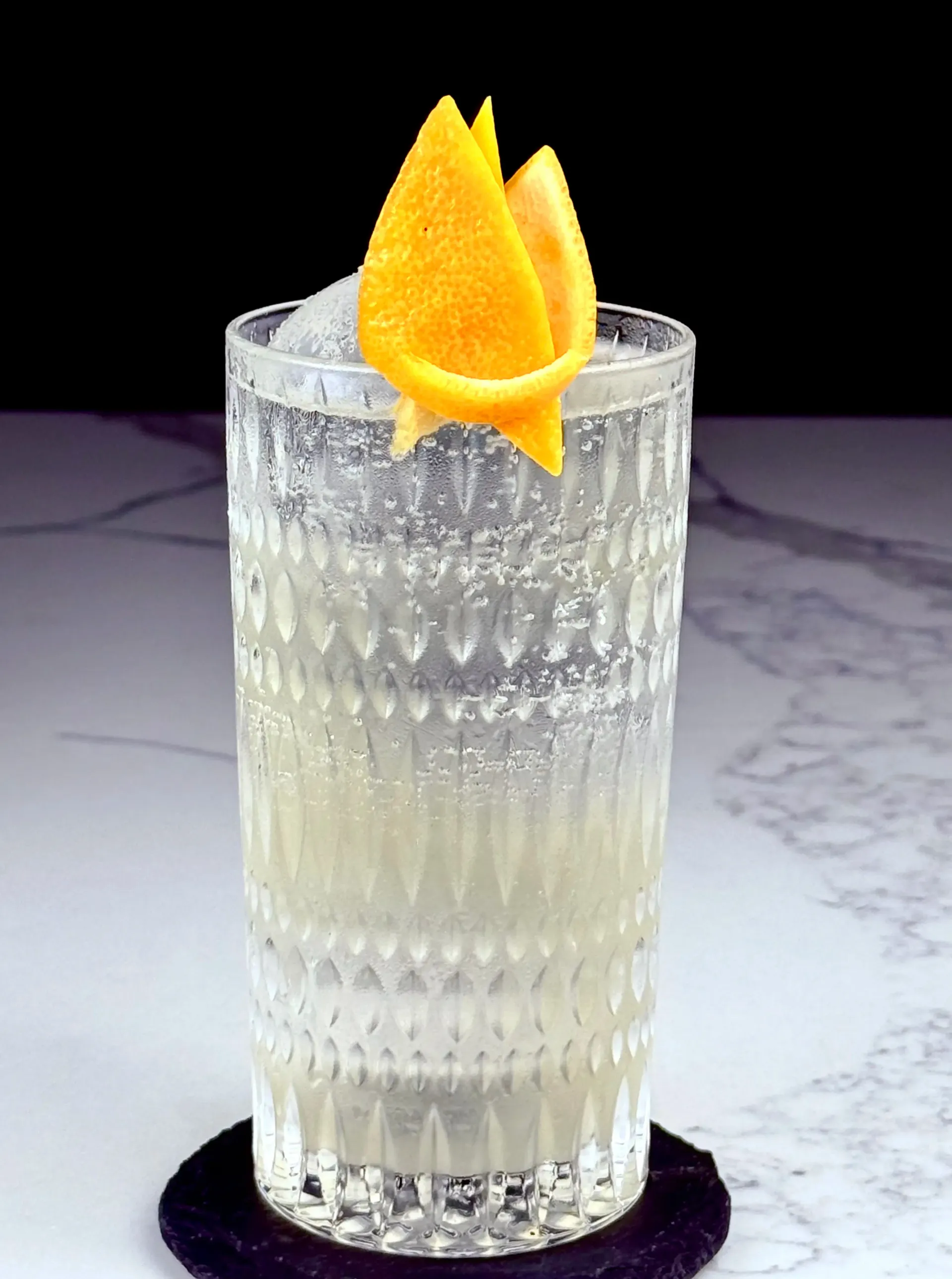 Hibiscus-Citrus Highball, a floral tequila highball lengthened with soda and finished with grapefruit aromatics