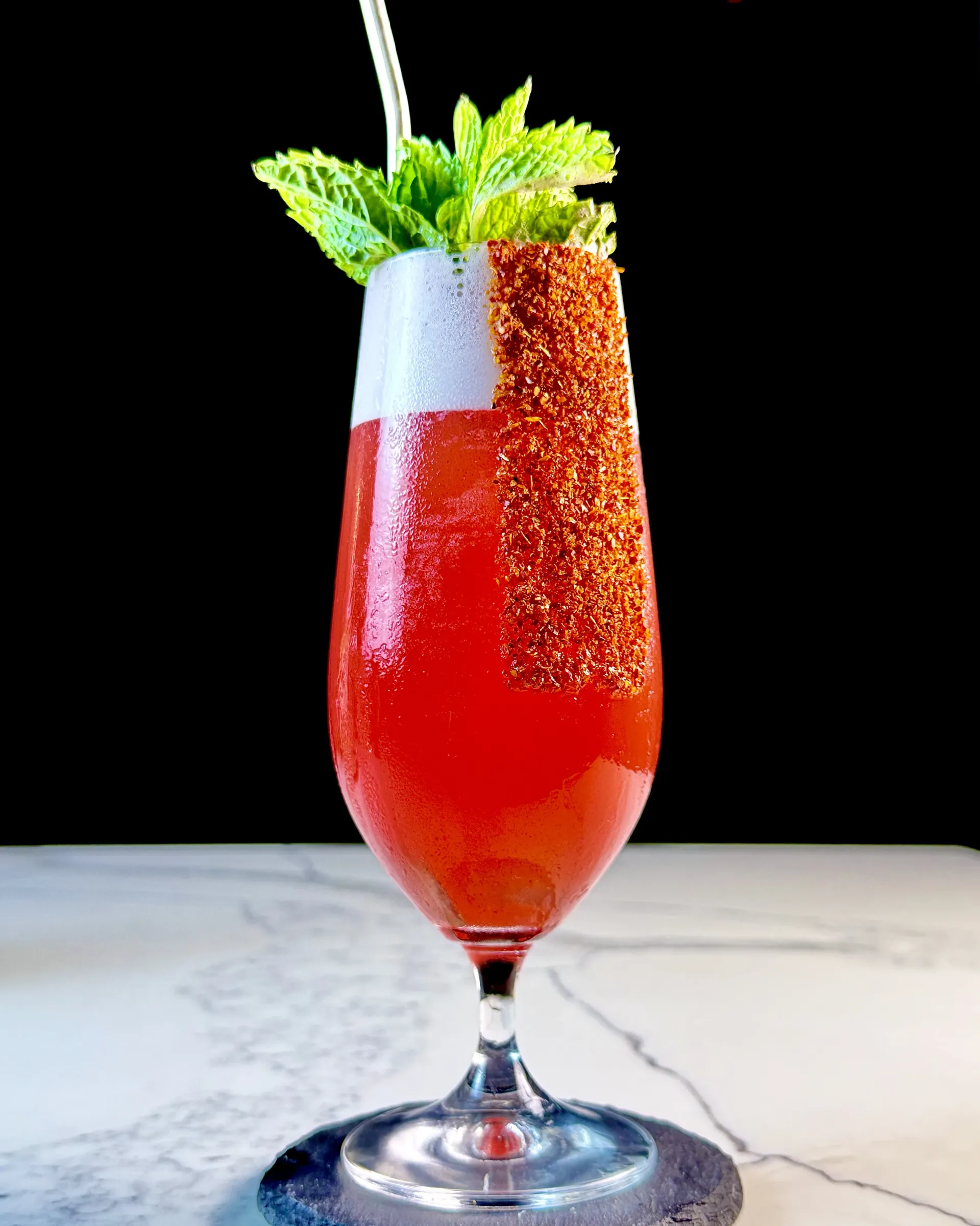 Adult Agua Fresca, a sparkling hibiscus-tequila highball with watermelon, mint, and a Tajín rim