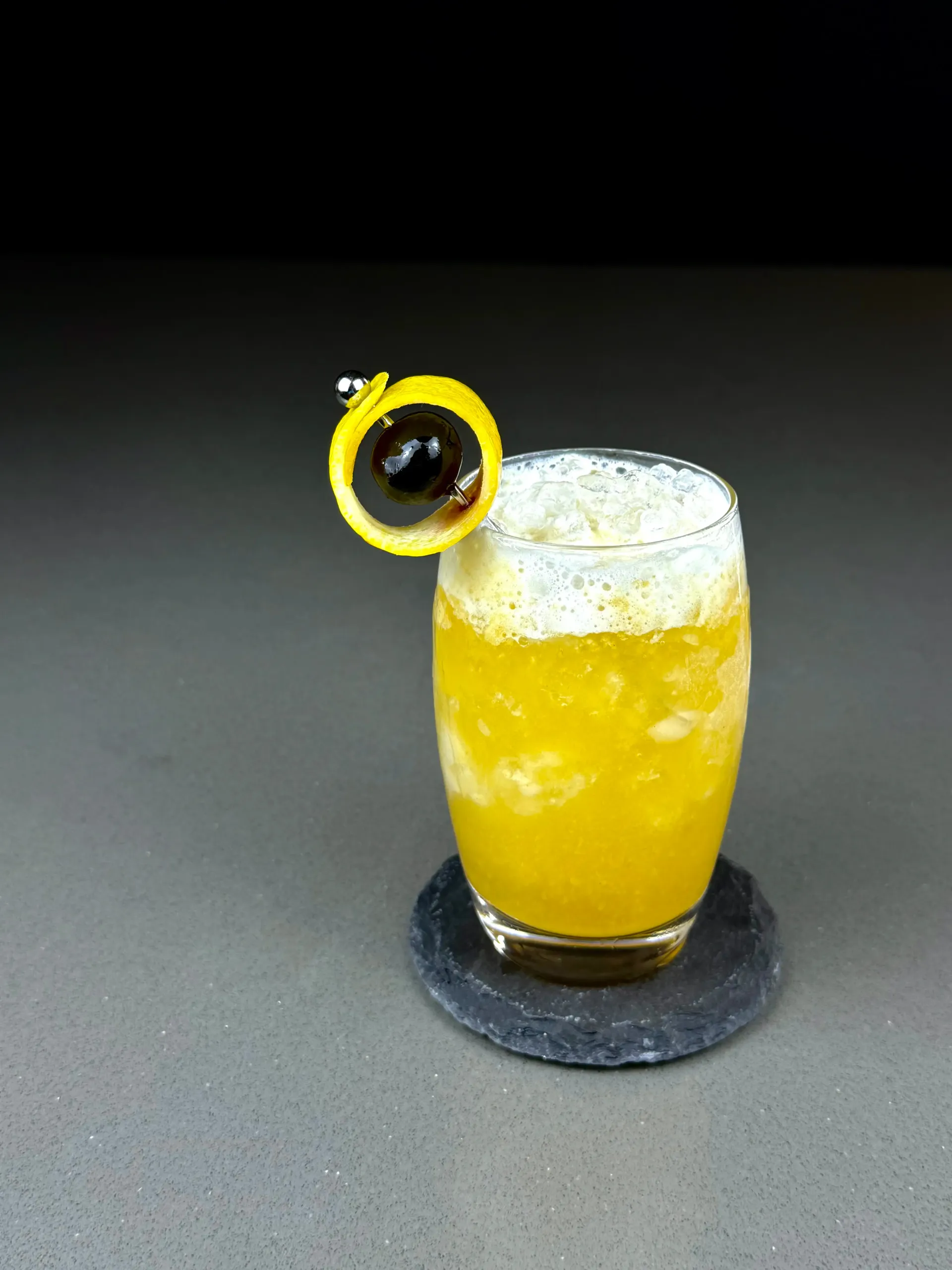 Ur-Ah-Nus, a gin-tiki passionfruit cocktail layered with almond, falernum, bitters, and crushed ice