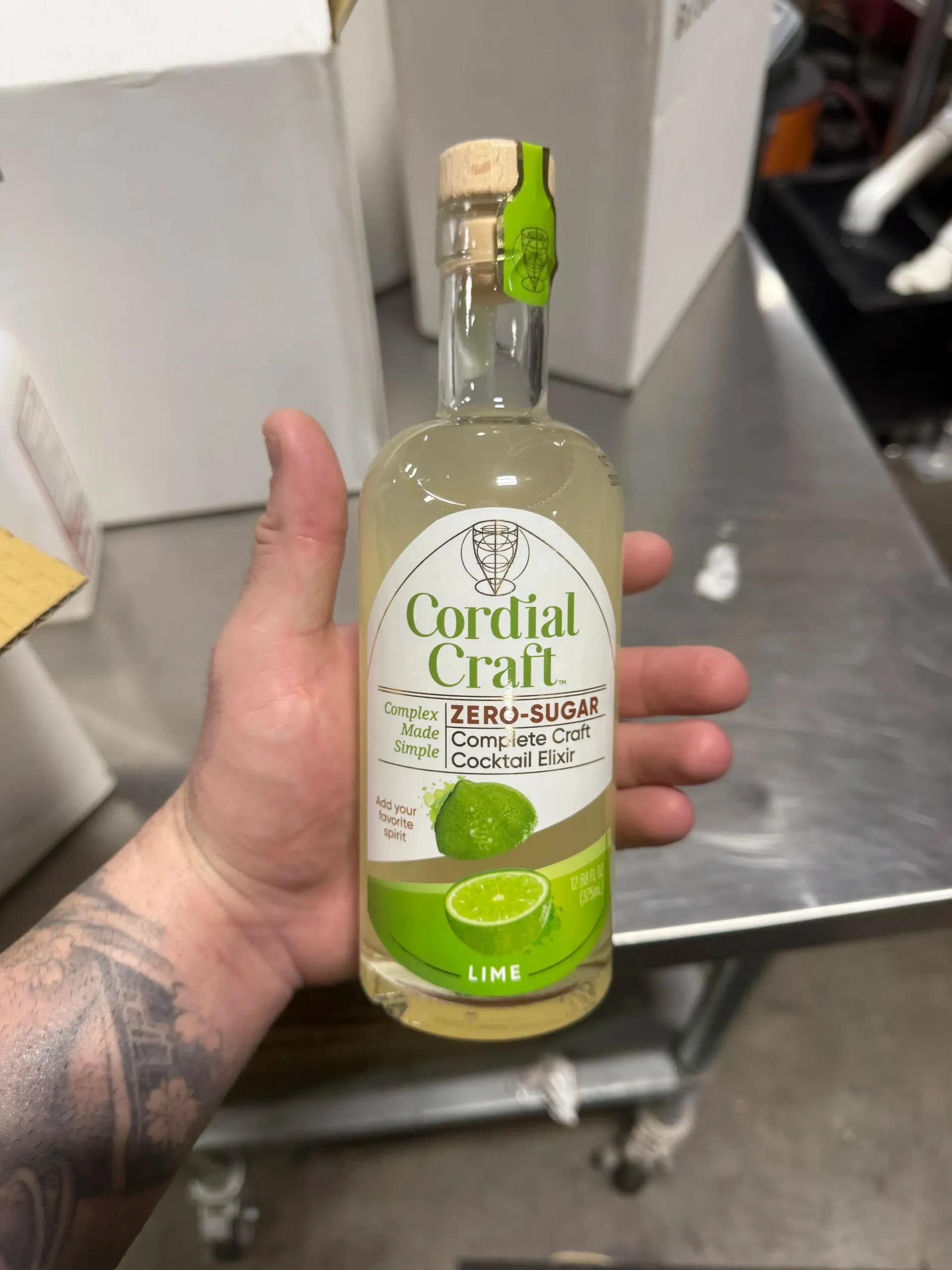 Cordial Craft founder Austin Davis holding a bottle of Zero-Sugar Lime Cordial