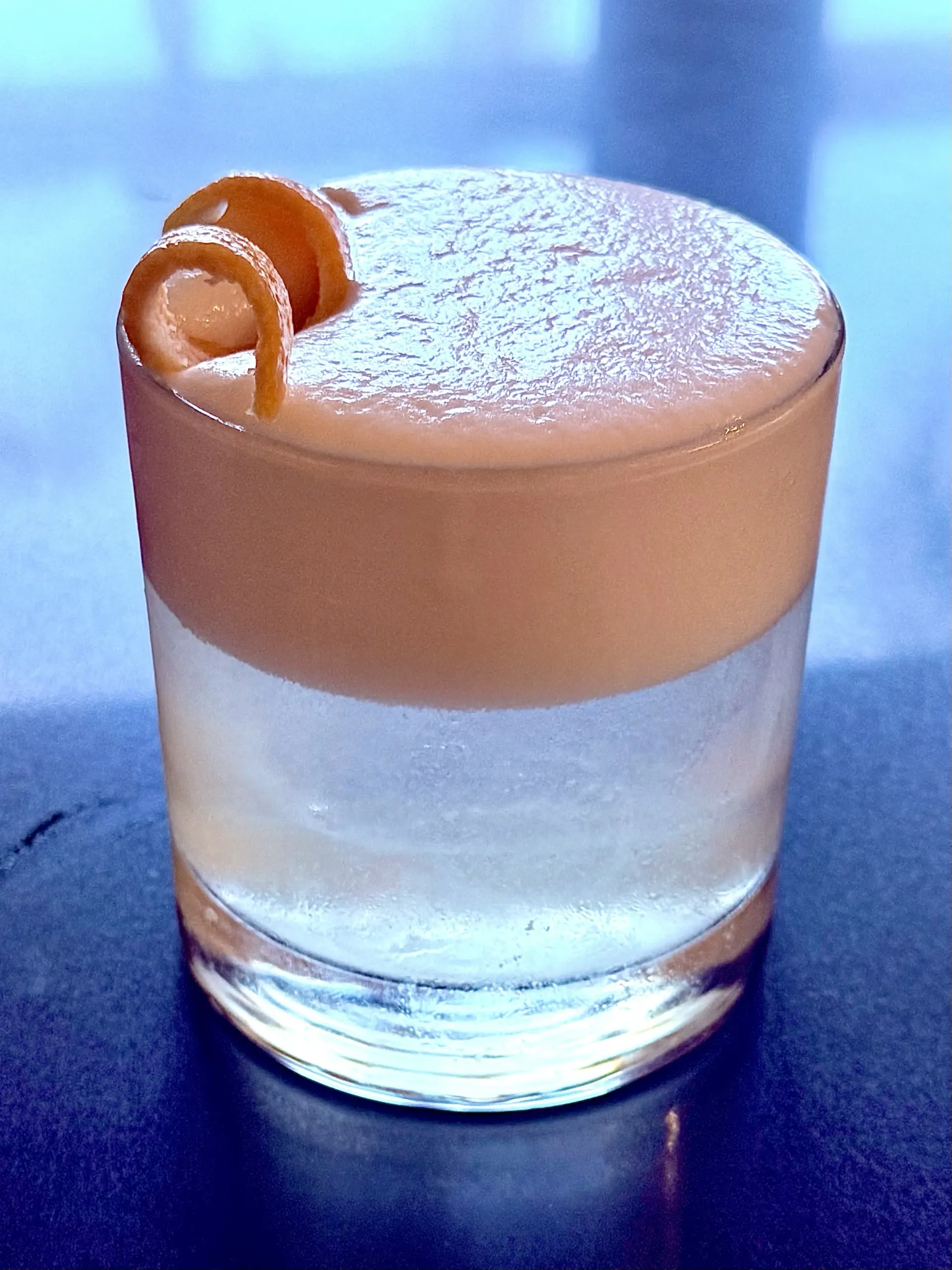 Rose Garden Sour, a grapefruit-rose vodka sour with velvety foam and an expressed grapefruit garnish