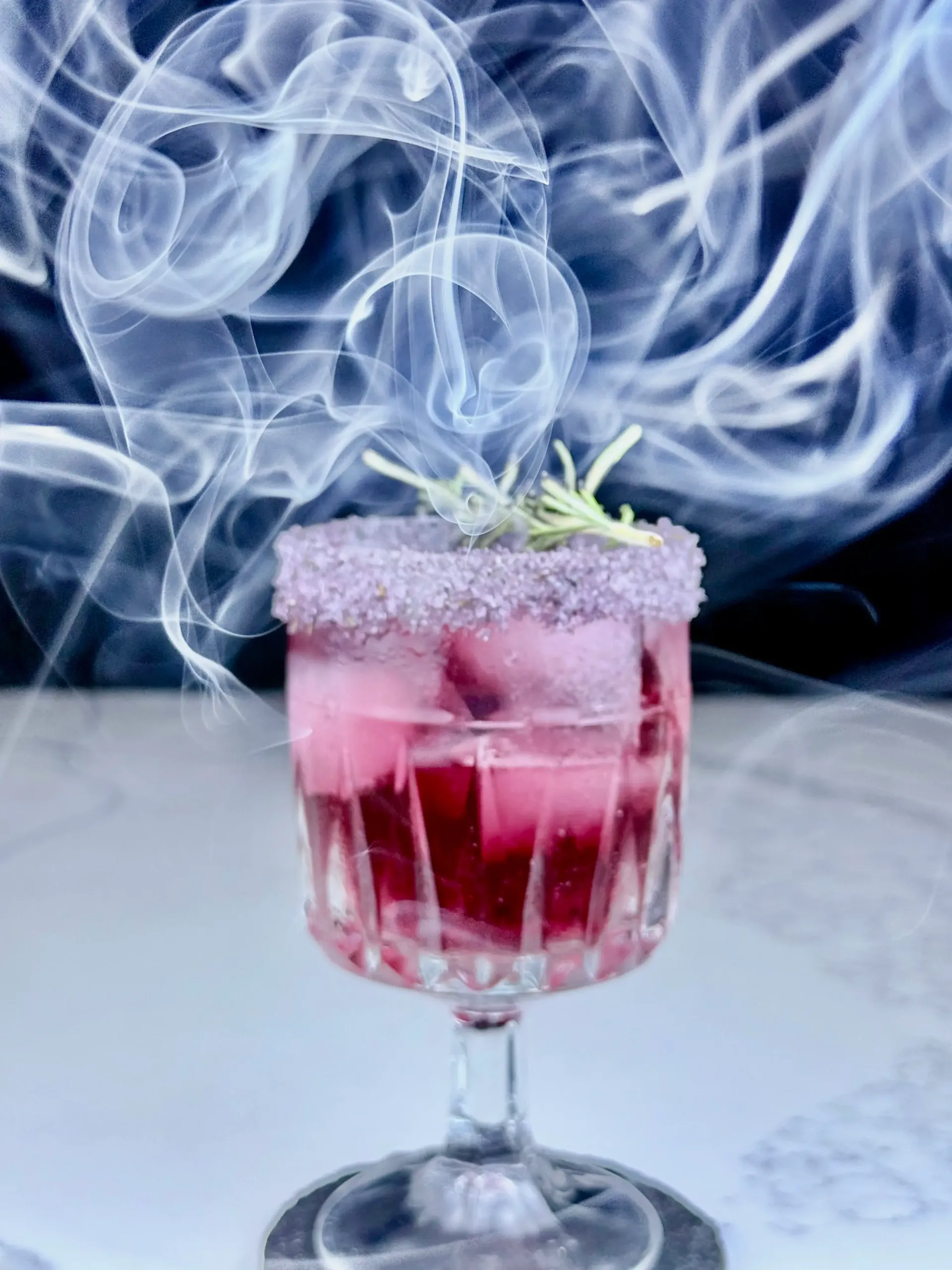 Margaux-Rita cocktail with rosemary smoke swirling around the glass