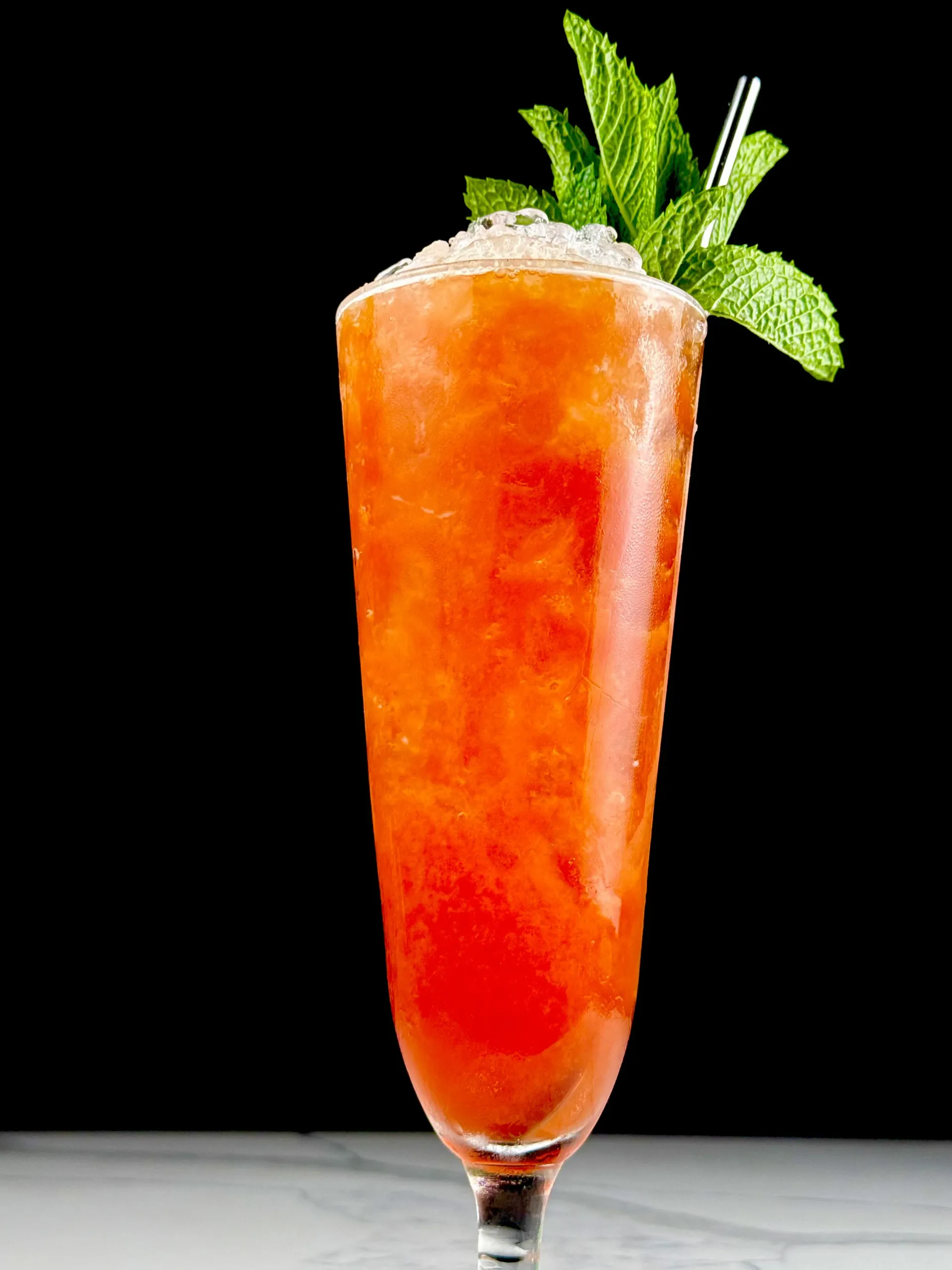 Hibiscus Hurricane cocktail with rum, passionfruit, and mint