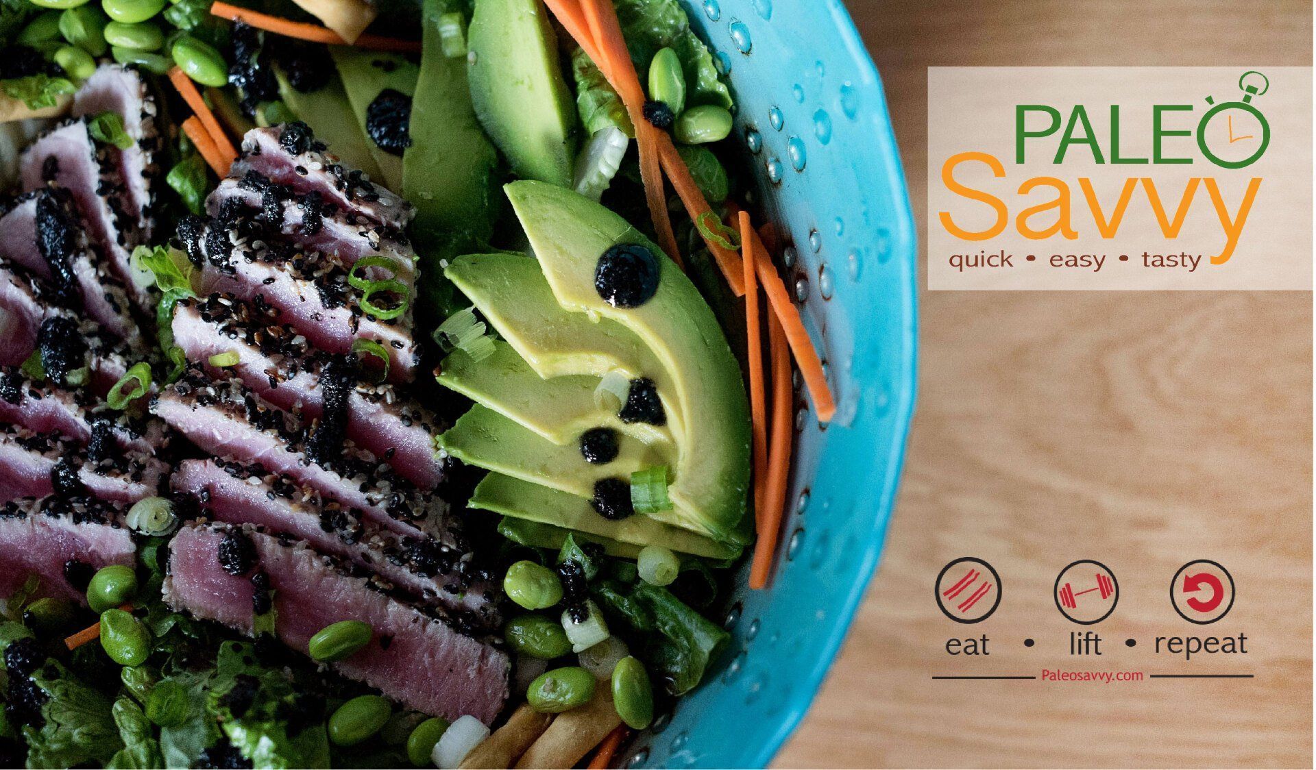 Paleo salad with sliced tuna, avocado, and edamame in a blue bowl.