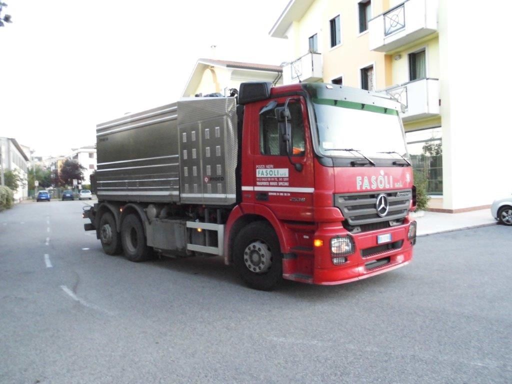 Un camion rosso è parcheggiato sul ciglio della strada