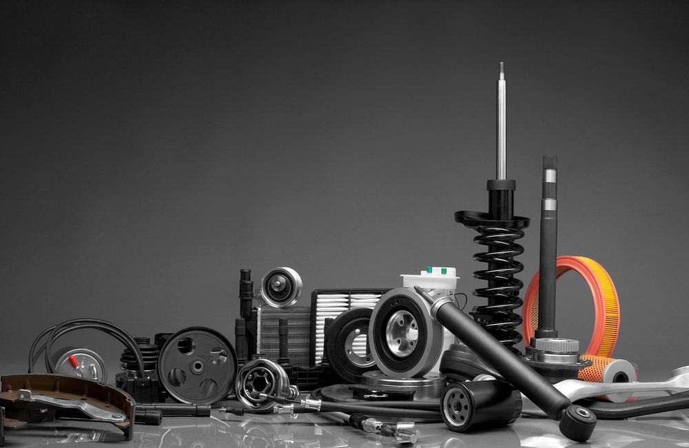 Collection of Various Black and Silver Car Parts on a Grey Background — Crypto Parts In  Tuggerah, NSW

