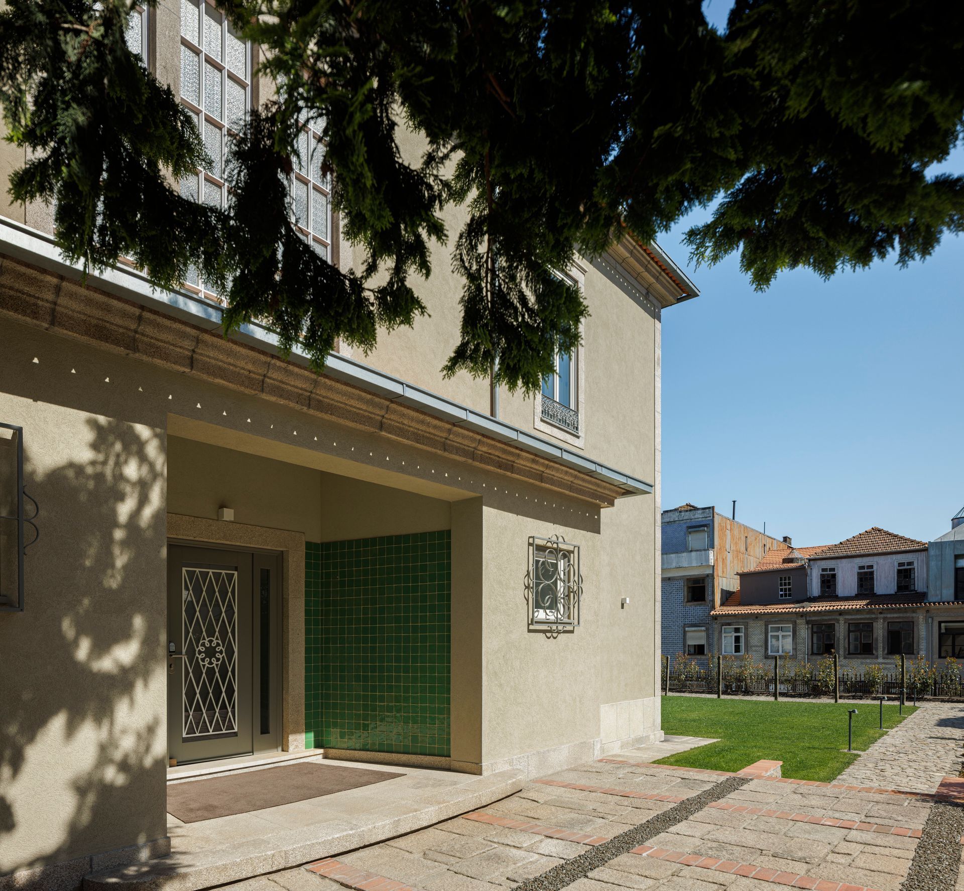 Facade of Casa Kala in Porto, Portugal, surrounded by private garden. 