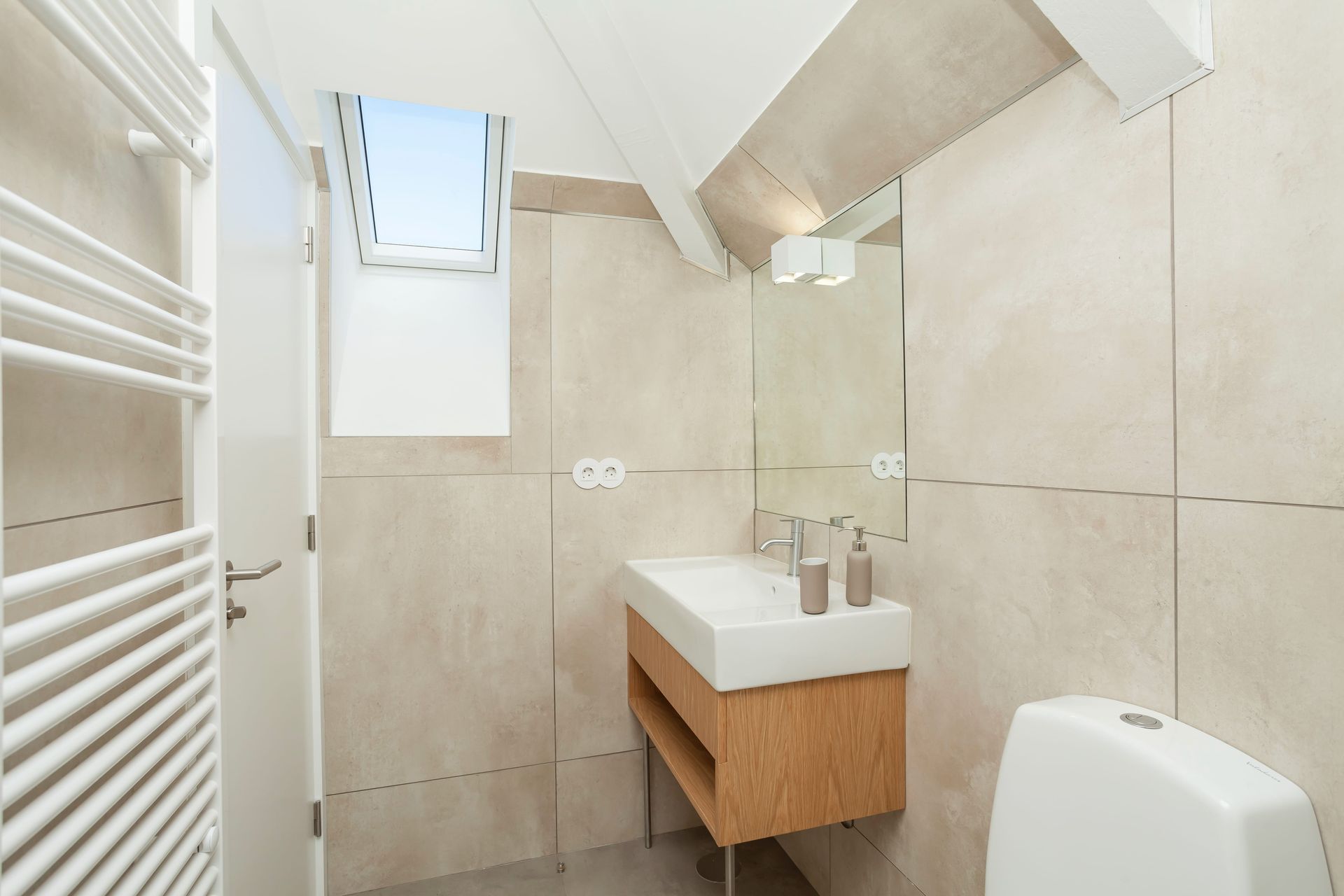 Private modern bathroom in the King Suite with large mirror and walk-in shower
