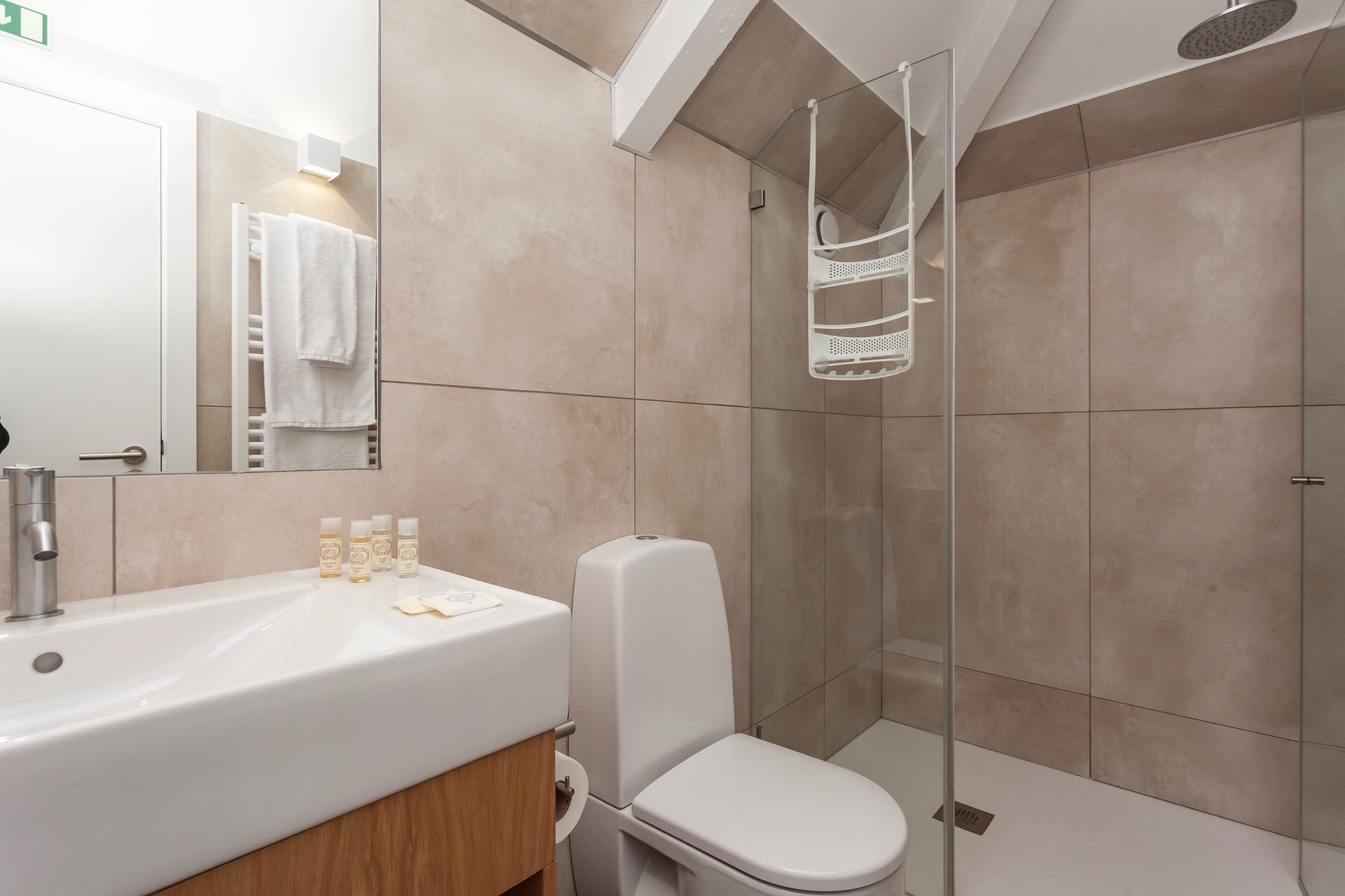 Private modern bathroom in the King Suite with large mirror and walk-in shower