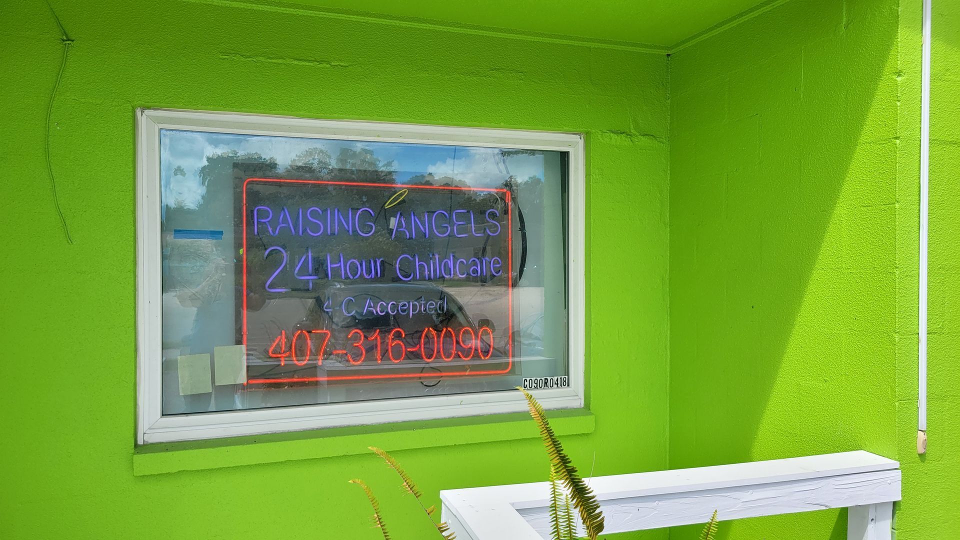 Exterior of Raising Angels building with signage.