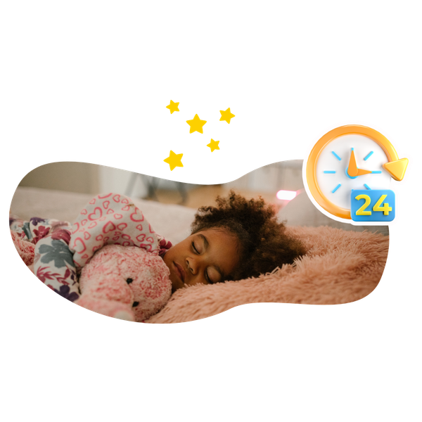 A little girl is sleeping on a bed with a teddy bear.