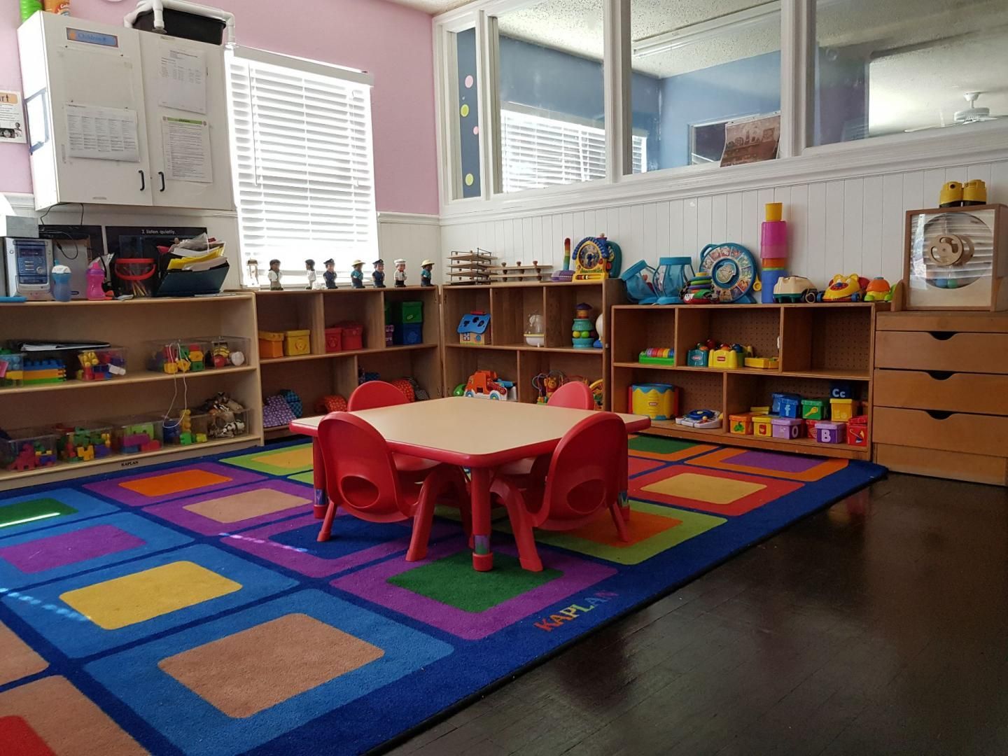There is a table and chairs in the middle of the room.