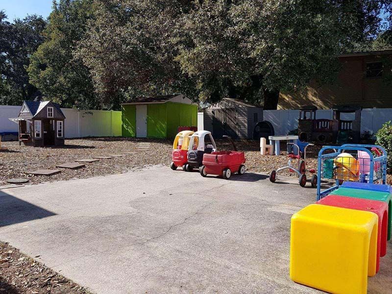 A row of toy cars are parked in a parking lot.