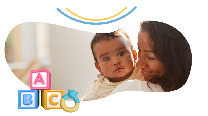 A woman is holding a baby in her arms.