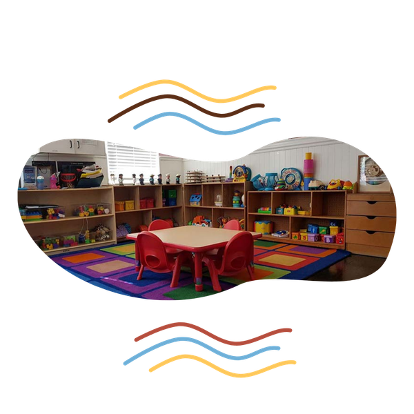 Classroom at Raising Angels with toys, tables, and chairs