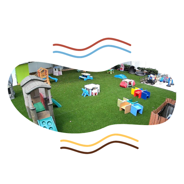 Outdoor playground at Raising Angels with slide, tables, and chairs