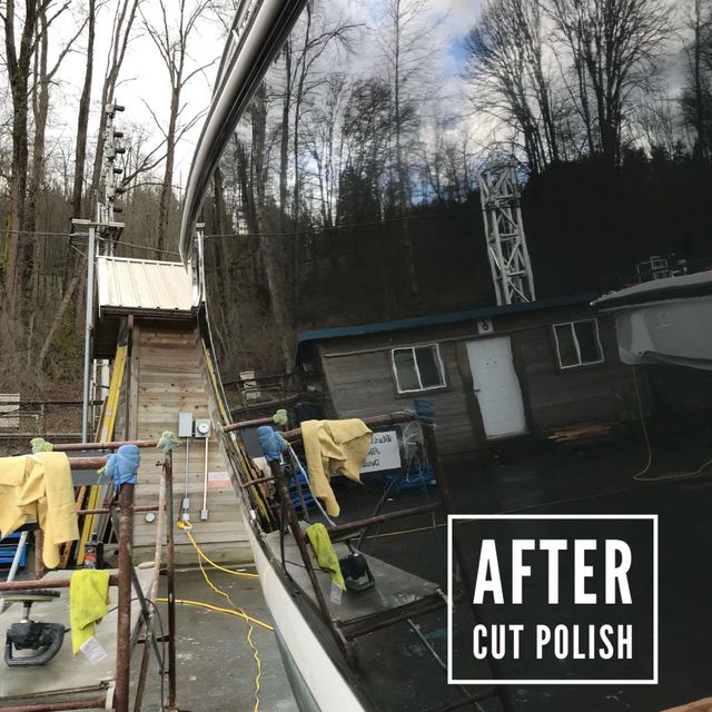 Black boat hull reflects the surrounding environment. Polished after cutting.