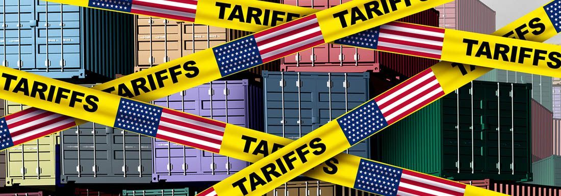 Torso, legs and feet of 3 basketball players, all bouncing balls. Each is wearing a different type of sneaker.