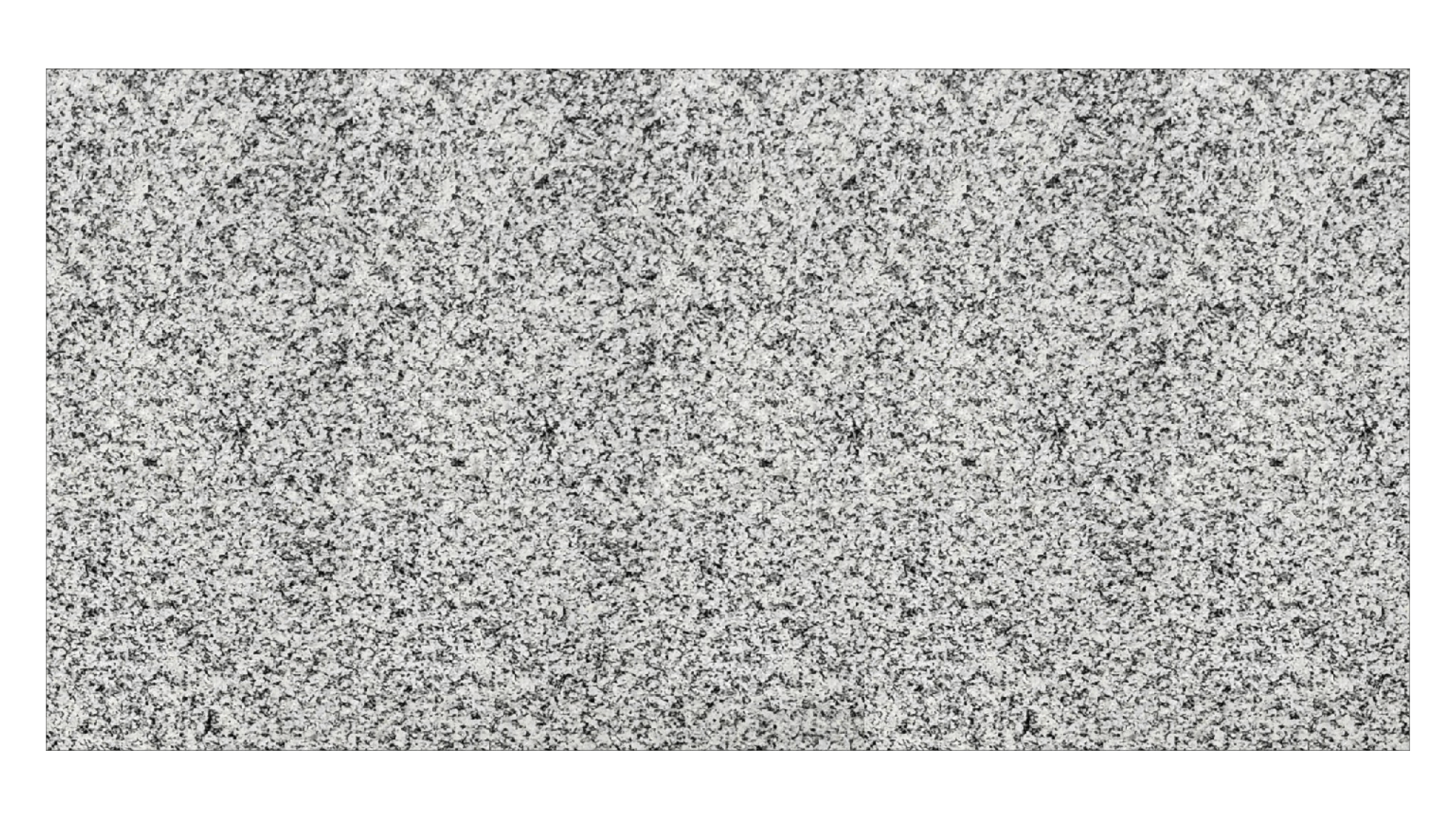 A close-up view of a light gray granite stone surface with a speckled black and white texture.