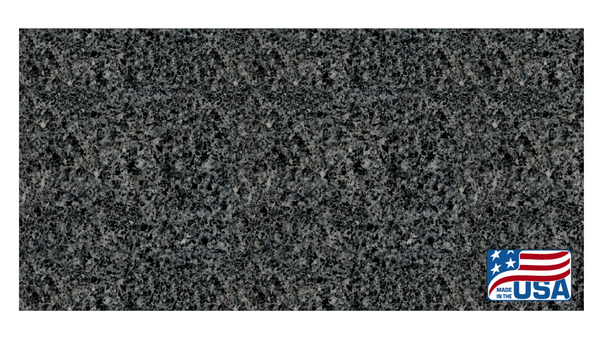 A rectangular piece of dark gray granite or stone with a speckled texture and a small American flag icon in the corner.