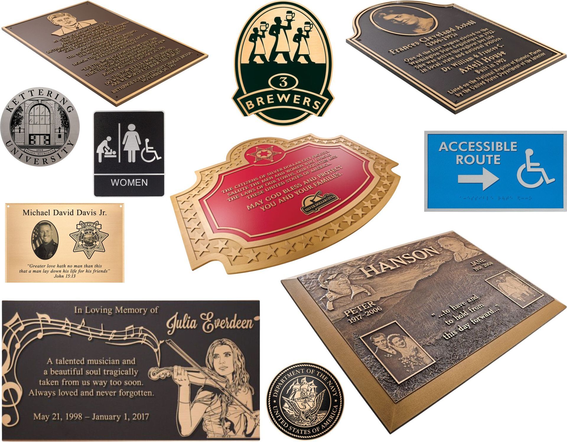 A collection of various custom-made metal plaques, memorial markers, and directional signage.