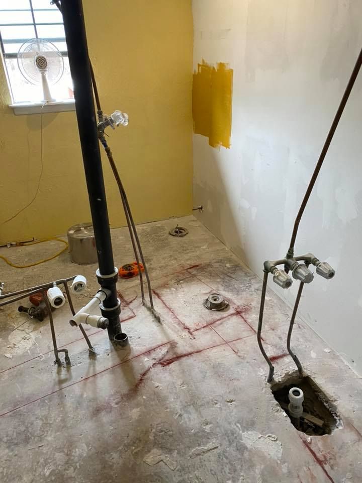 A bathroom under construction with a hole in the floor.