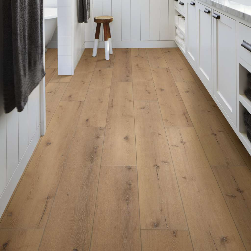 A bathroom with a wooden floor and white cabinets
