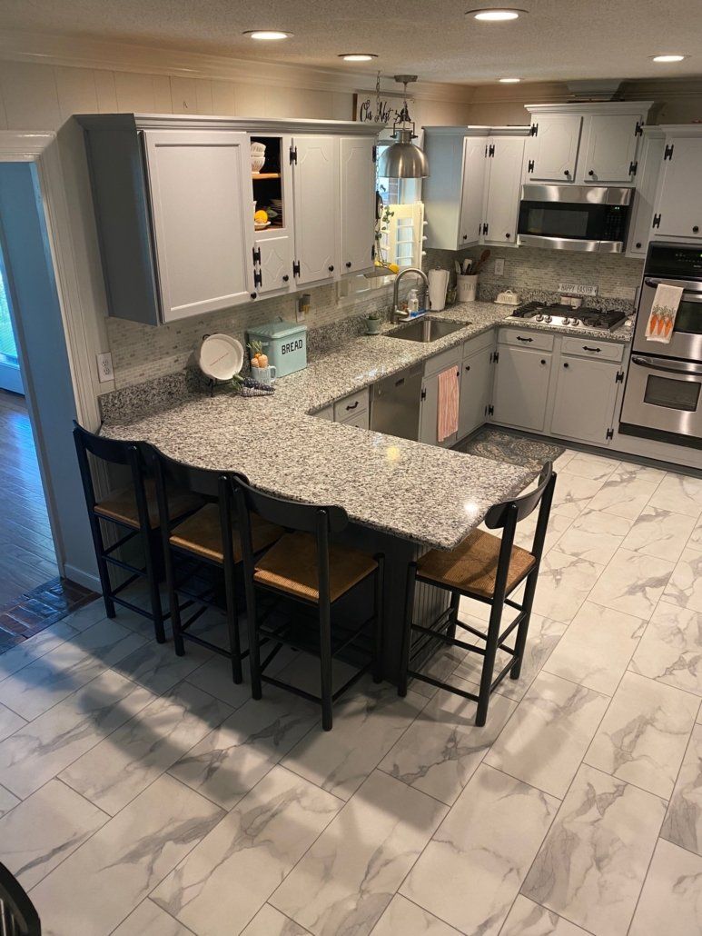 A kitchen with granite counter tops and stainless steel appliances