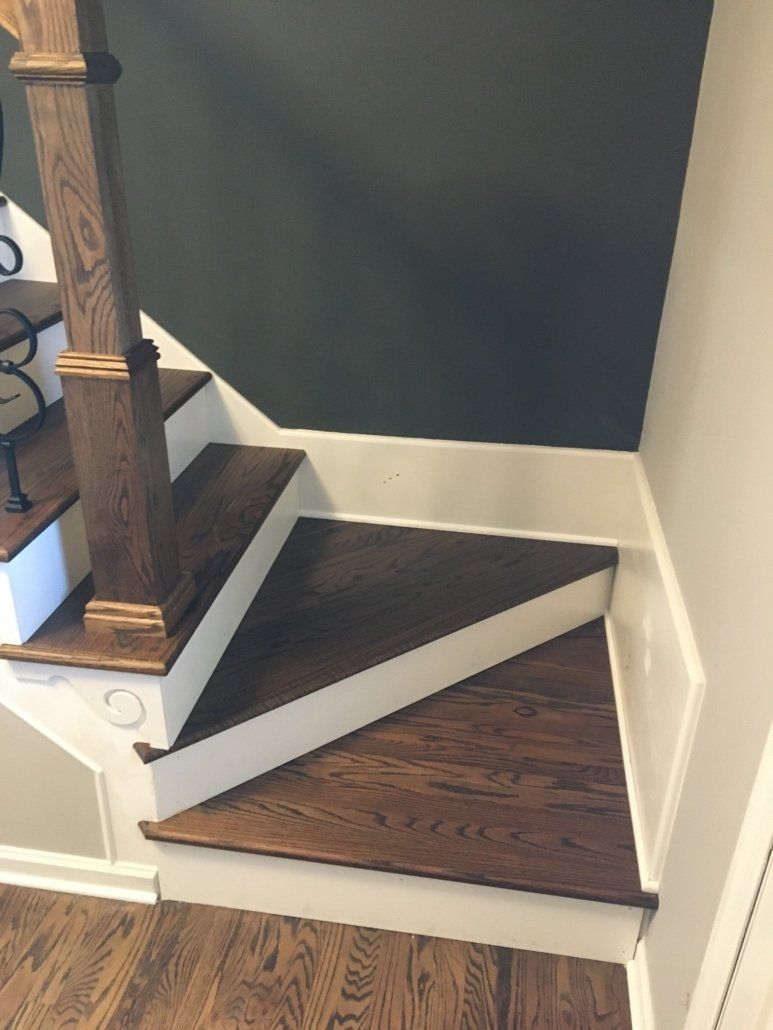A staircase with wooden steps and white railing
