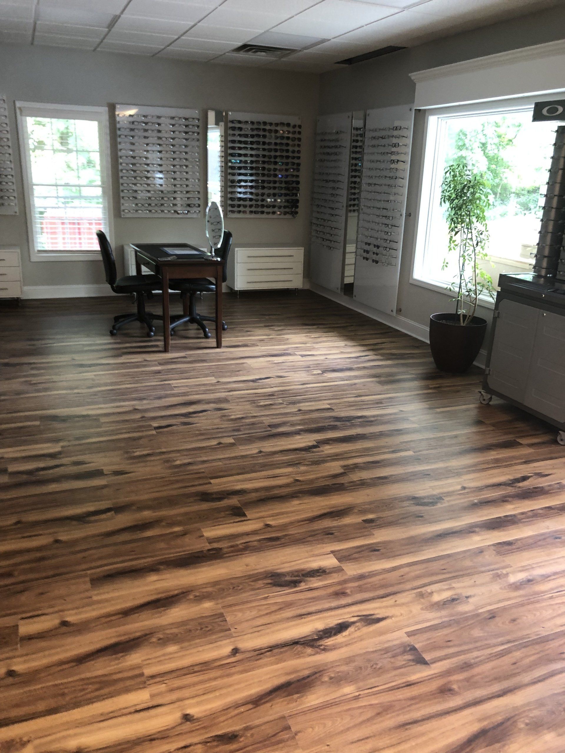 A large room with wooden floors and a table and chairs in it.