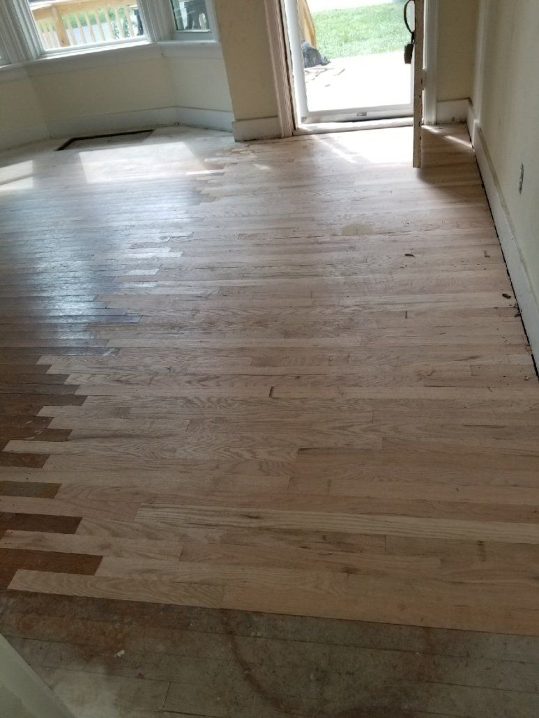 A room with a wooden floor and a door