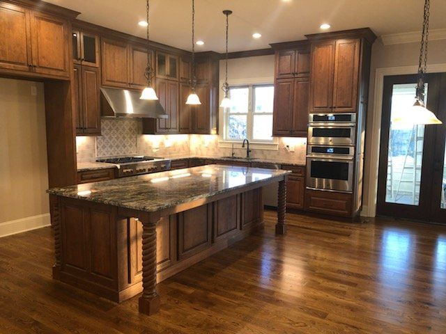 A kitchen with stainless steel appliances and wooden cabinets