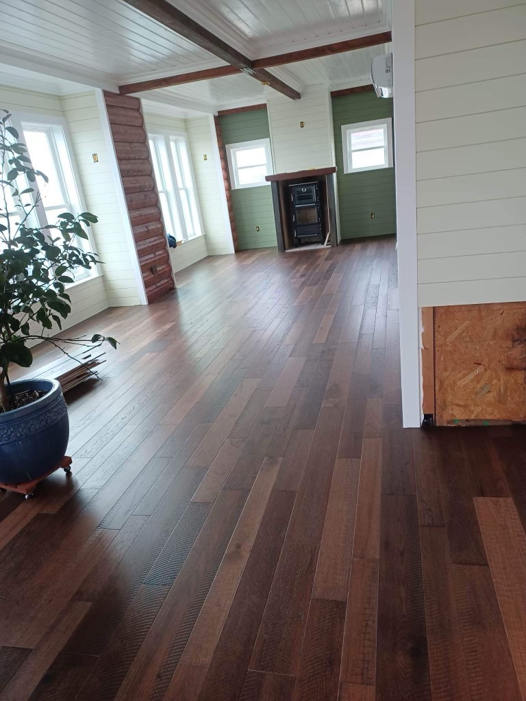 A living room with hardwood floors and a fireplace.
