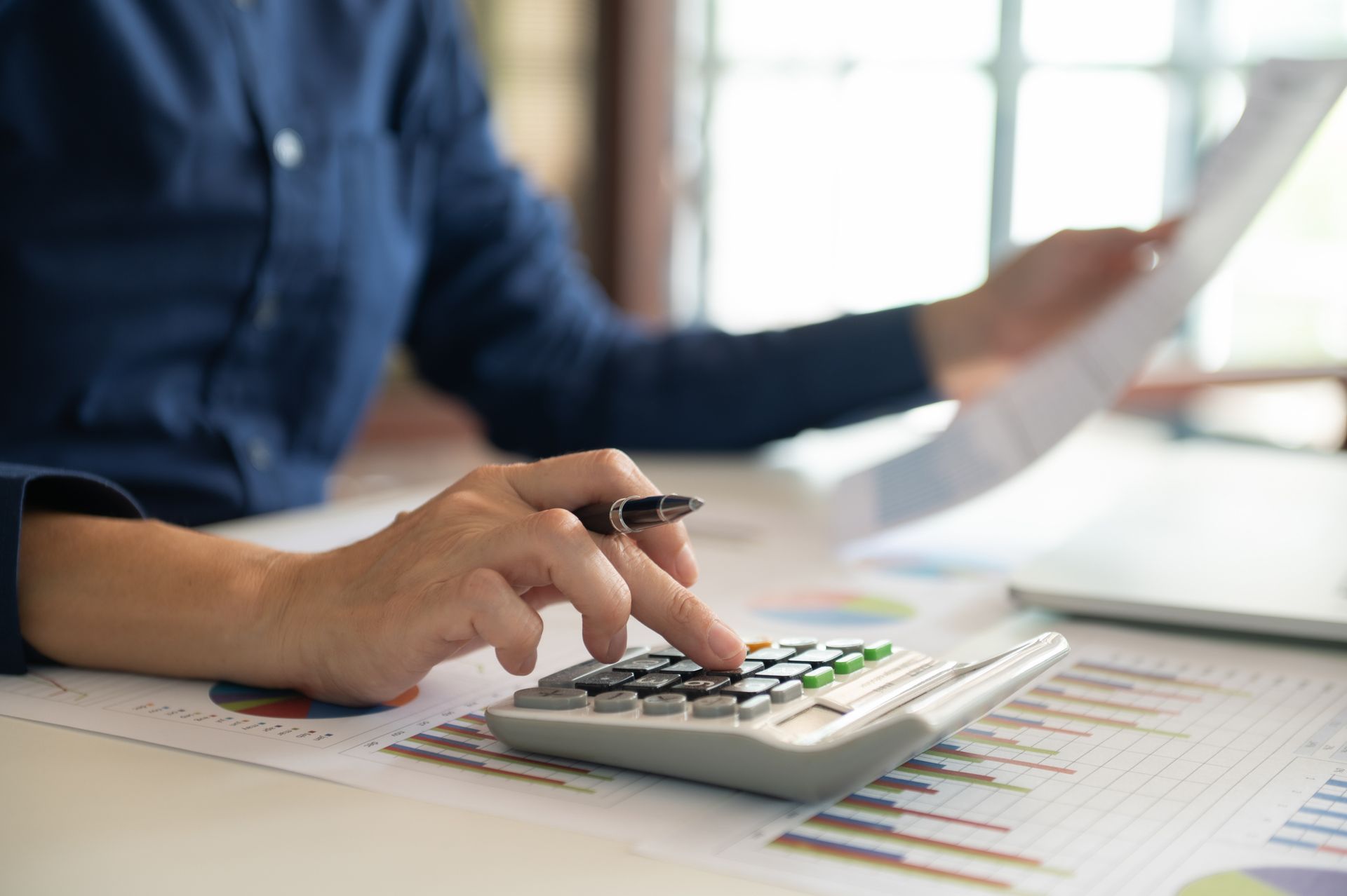 Man With Blue Shirt and Calculator Filling Forms, Concept for Depreciation Report | Geelong, VIC