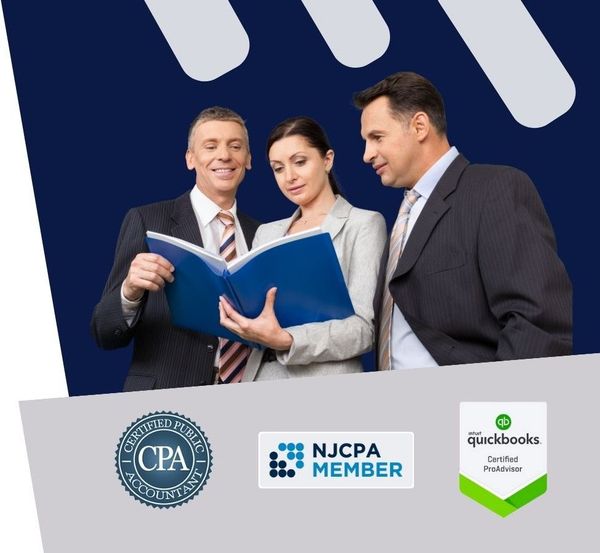 Two men and a woman are looking at a book together