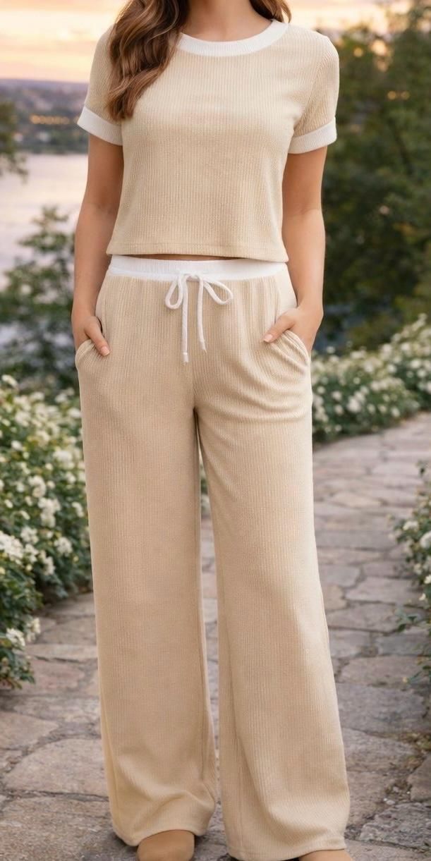 Beige short-sleeve top and matching wide-leg pants with a drawstring waist, worn outdoors.